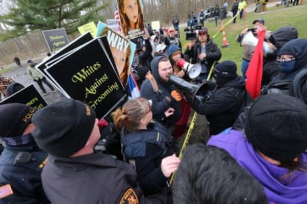 Protesters co<em></em>nfront each other with one side holding signs saying ‘Whites against grooming’.