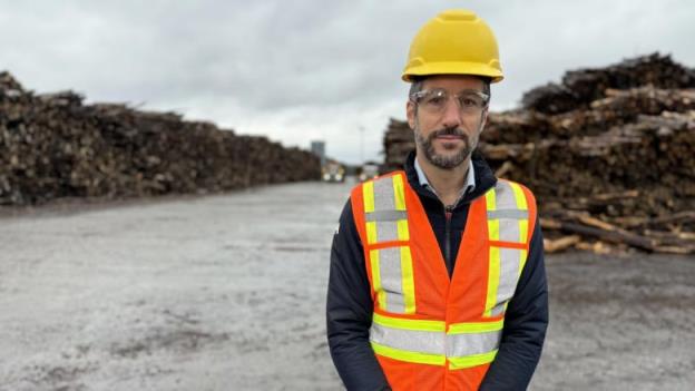 Man standing in front of lumber