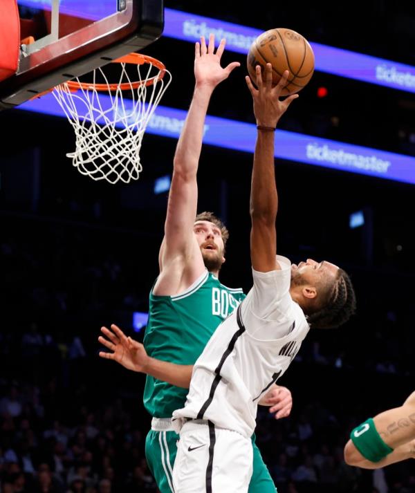 Brooklyn Nets forward Ziaire Williams (R) puts up a shot past a defending Boston Celtics center Luke Kornet (L) in the first half at the Barclays Center