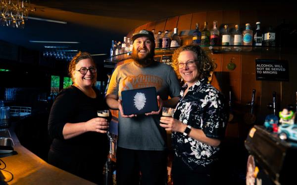 (From left) NIWA marine invertebrate systematist Rachael Peart, Fork and Brewer head brewer Brayden Rawlinson (holding an image of the Pentaceration forkandbrewer) and NIWA marine biologist Kareen Schnabel.