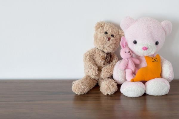 Stuffed animals sitting on a shelf