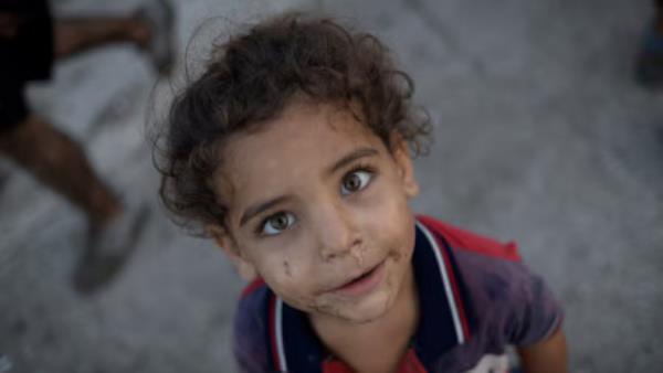 A displaced kid reacts to a camera outside his makeshift shelter at a roadside, amid the o<em></em>ngoing hostilities between Hezbollah and Israeli forces, in Beirut, Lebanon November 8, 2024. REUTERS/Adnan Abidi/File Photo