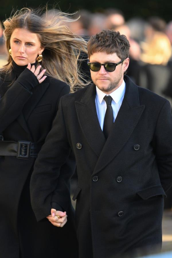 Amelia Woolley and Niall Horan depart the funeral for singer Liam Payne.