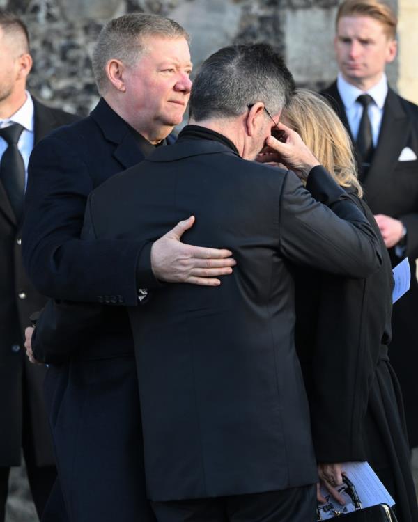 Simon Cowell is comforted by Geoff Payne (L) as they depart the funeral for singer Liam Payne, former member of One Direction, on November 20, 2024 in Amersham, England.