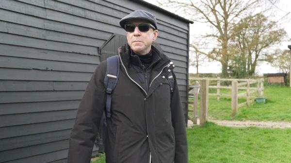 Mark Dyer reacts as he stands on the spot he believes his grandma could be buried